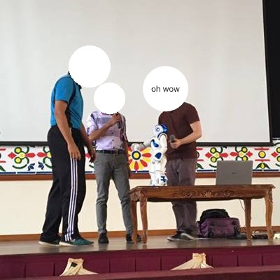 A picture of the NAO robot interacting with a student in a school called MRSM Felda, Trolak.